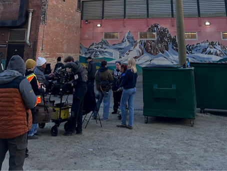 A film crew in a back alley beneath the Calgary tower.