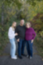 teenage daughter with her parents in fall family photo in Rosemount MN surrounded by fall colors