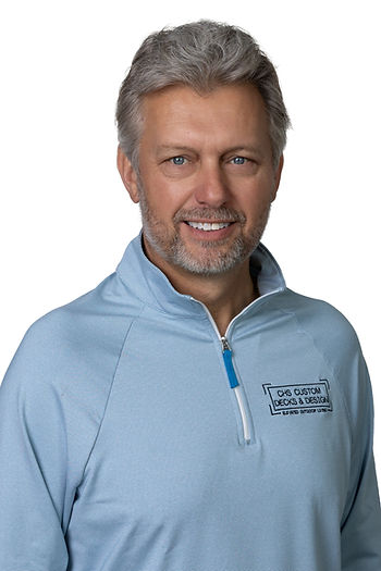 studio headshot of gentleman in blue quarter zip