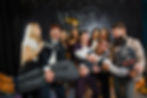 A group of company colleagues having fun posing in front of a photobooth on a christmas party
