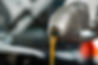 partial-view-of-mechanic-pouring-motor-oil-from-bo-2026-03-12-23-56-19-utc.jpg