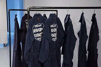 Worker coveralls with hand embroidered foundry worker text.