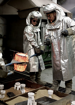 Skimming surface of molten bronze.