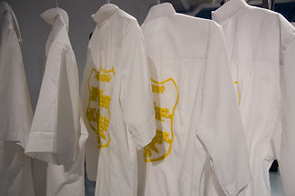 Uniform tops with hand embroidered foundry text.