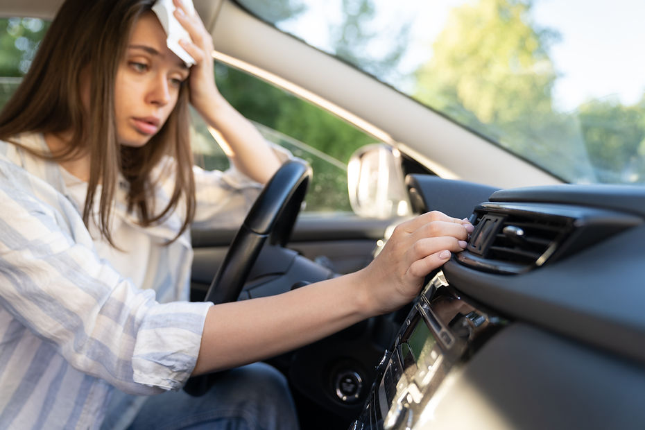 Girl driver has problem with a non-working conditioner, hand checking flow cold air, being