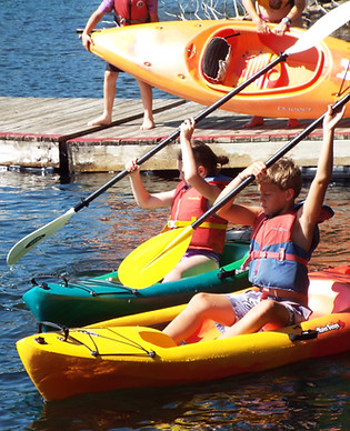 two kids paddling kayaks.JPG