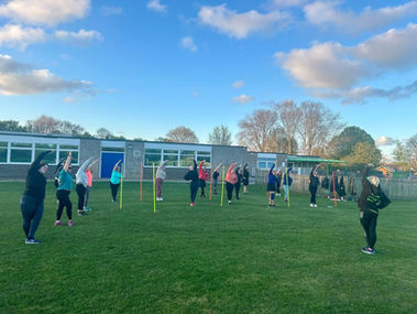 Week two beginners performing cool down stretches 
