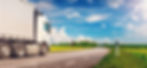 Truck moving on the asphalt country highway in sunny day in spring. Concept of logistic an