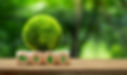 Green Logistics concept. A small globe covered in green sits on top of four wooden blocks