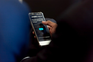 Audience member using phone to participate during the CRLF forum in 2026