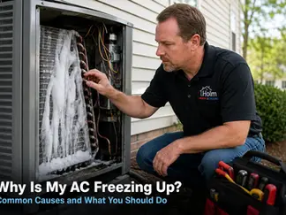 HVAC technician inspecting a residential air conditioner with a frozen evaporator coil in Wake Forest, NC