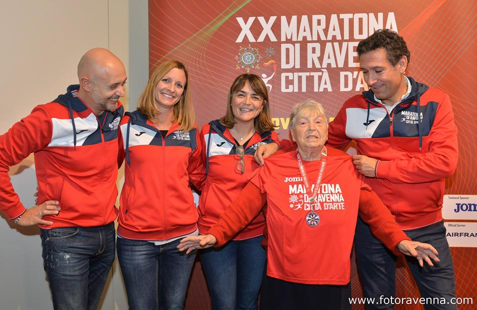 Old lady presented with medal for high fiving marathon runners