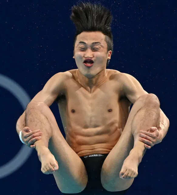 Olympic Diver with funny face and hair flying upwards