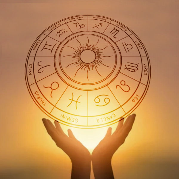 Solar Return Chart Reading from Read by Renee to understand your year ahead based upon an astrological chart created for a specific year and location of your choosing. This image is a zodiac wheel held up by two hands and in front of a sun.