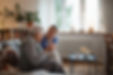 Caring healthcare worker visiting a senior patient at home, talking with her in living roo
