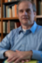 Photo of Robert Englebretson with books behind him.