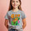 Thumbnail: CAT Graphic T-Shirt with Cartoon Cat on Armchair and Floating Fish