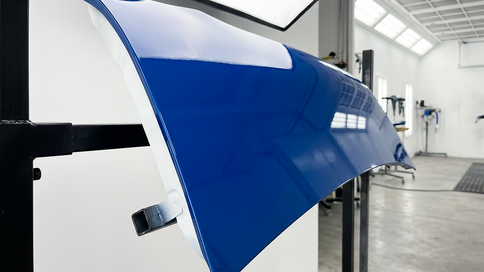 Eye-level view of a freshly painted car panel with smooth glossy finish