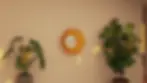 Orange wall sconce The Aureolis Wall Sconce, hanging on a peach wall; Haydn.in
