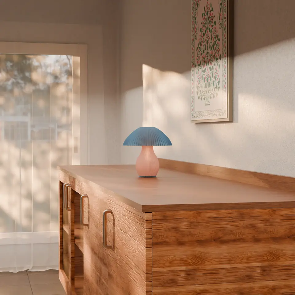 Blue Luma Dome Mushroom shaped lamp side on view on the table