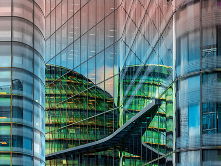 Reflections across a modern glass building illustrating how a commercial proposition can be experienced differently.