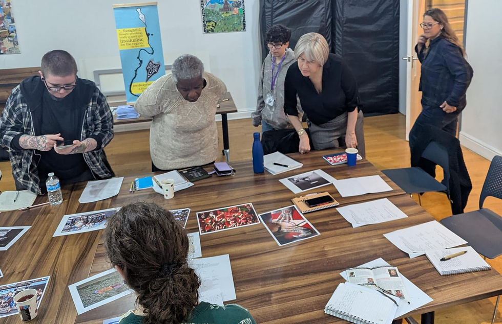 Women around a table looking at images,