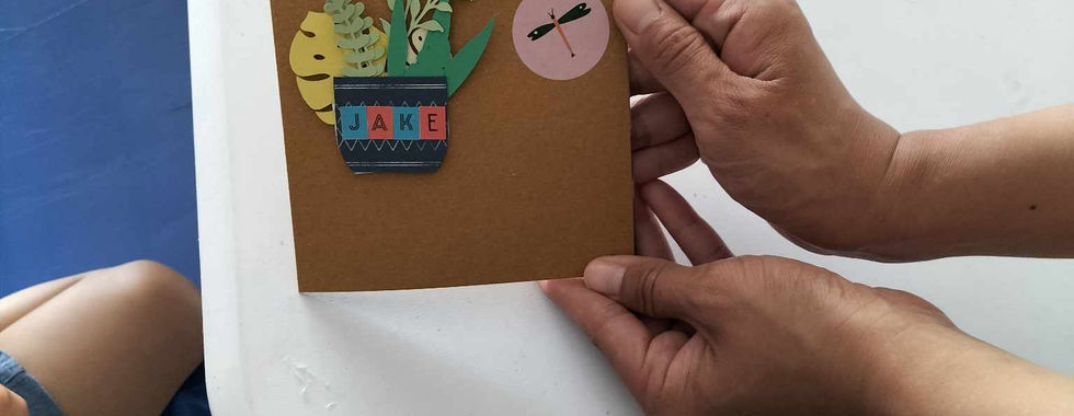 A young boy's hands holding a card handmade by him at Crafting
