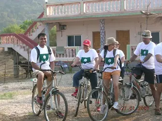 Group of people enjoying a cycle tour, exploring the outdoors on bicycles as part of their adventure with The Explorers