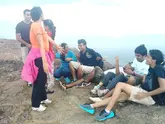 Group of people enjoying the view from the top of a point, celebrating their achievement during a tour organized by The Explorers.