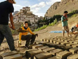 Students learning the process of brick-making in a hands-on community program