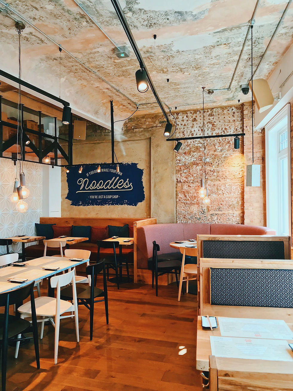Restaurant interior featuring exposed brick walls, pendant lighting, and structural design by AKS Structures