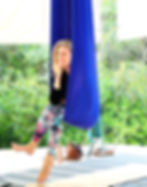Floating in a hammock in an aerial yoga class at the House of Honey Aerial Retreat Center