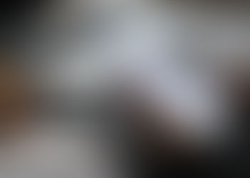 Hands use a smartphone on the LinkedIn login screen beside a laptop, coffee cup, and pencil on a desk.