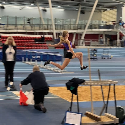 Bethany in full flight, securing long jump personal best. Photo by Lewis Parsons