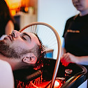 Man enjoying a calming scalp massage during a head spa session in Guildford.