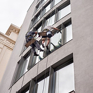 two-workers-washing-windows-outside-building.jpg