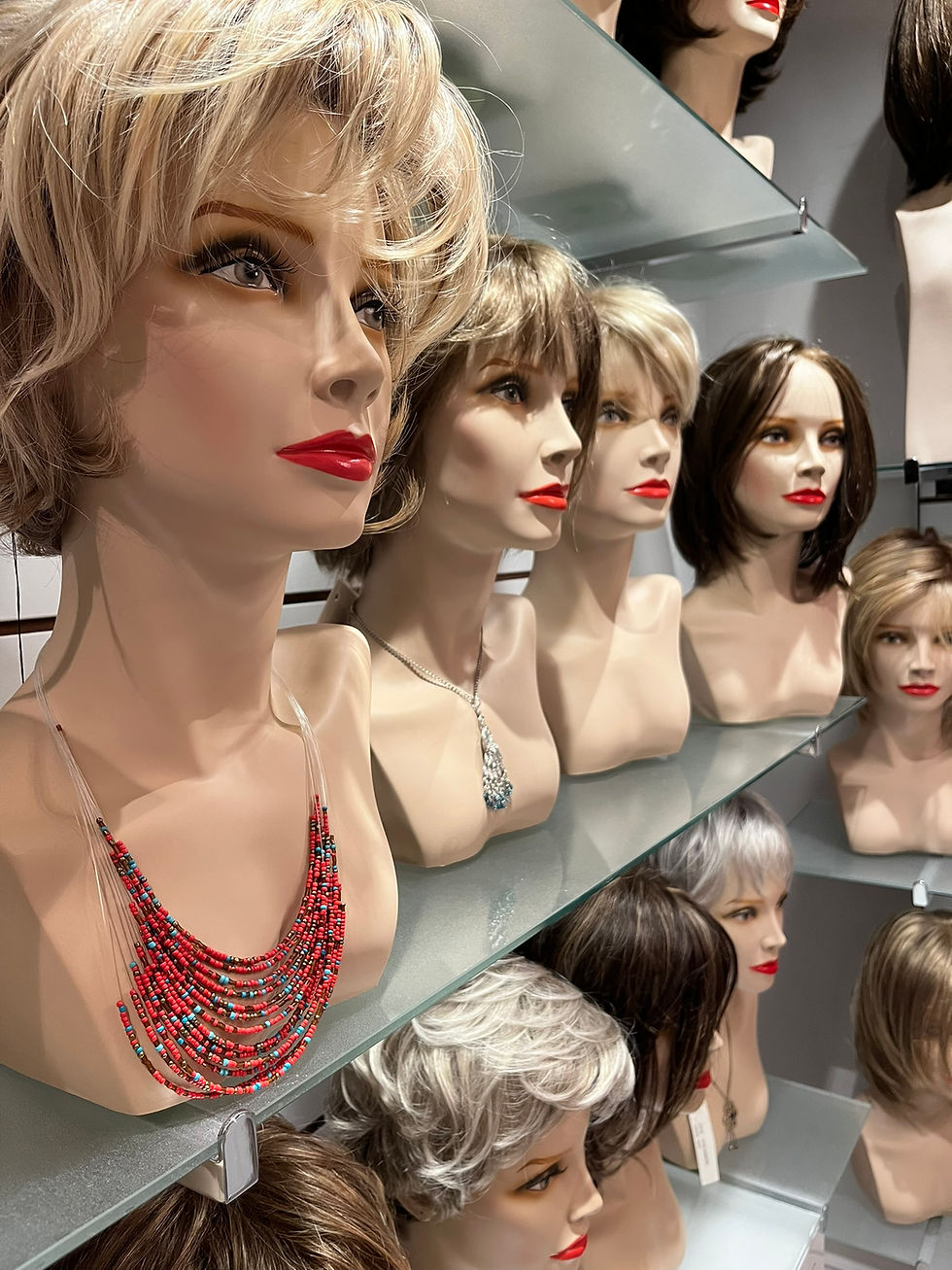 Eye-level view of a display of various hair prostheses in a boutique