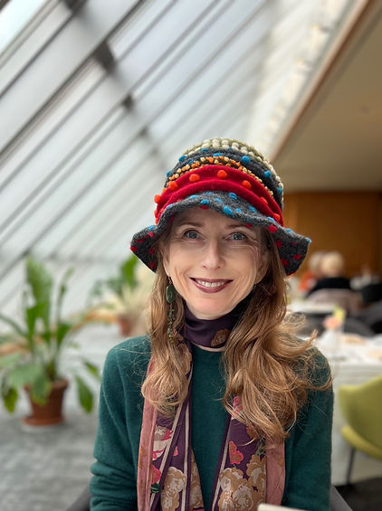 Woman wearing multicolored felt hat and smiling