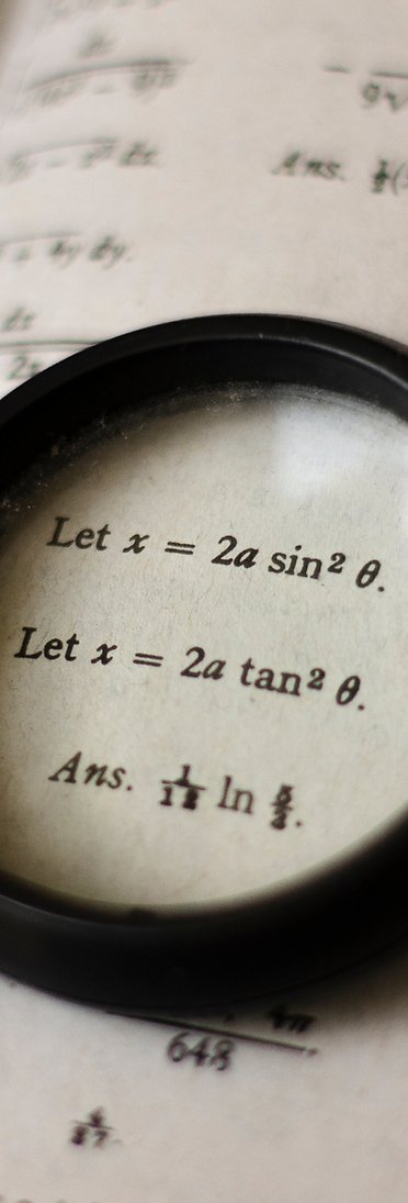 Magnifying glass lying on top of a calculus math problem