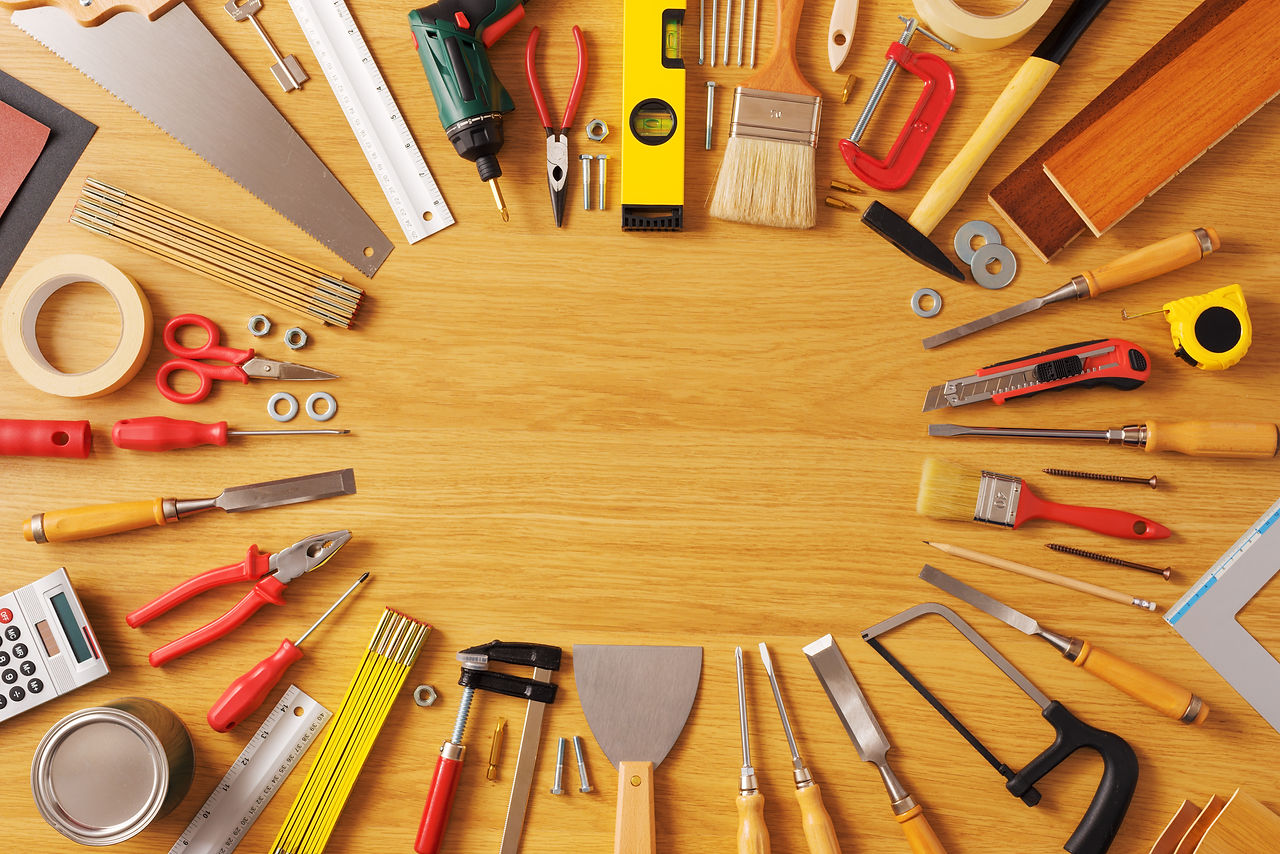 DIY and home improvement banner with work and construction tools on a wooden workbench top