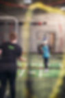 360U softball player inside the batting cages, improving their swing with 360U coach.