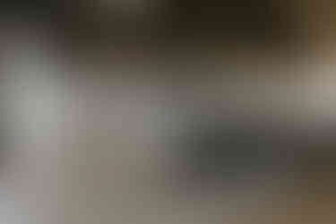 A room full of black chairs ready for a wedding at the fox club