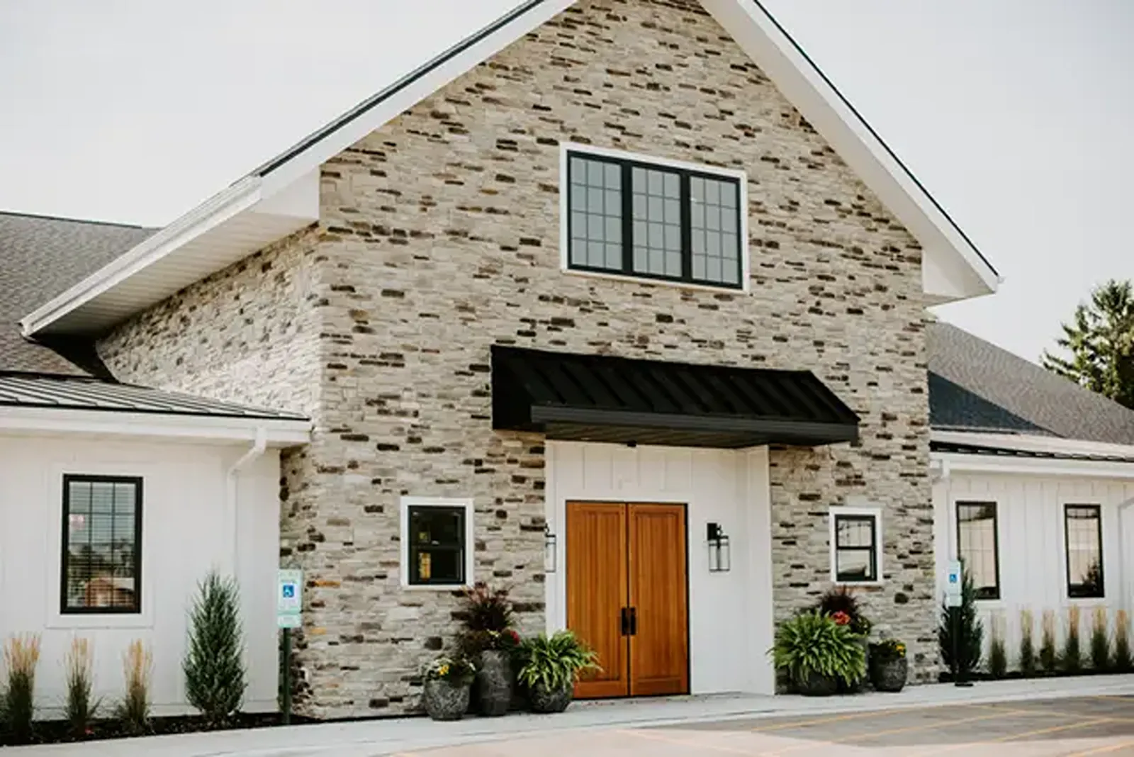 The front of the LedgeCrest Reserve with brick and brown front doors.
