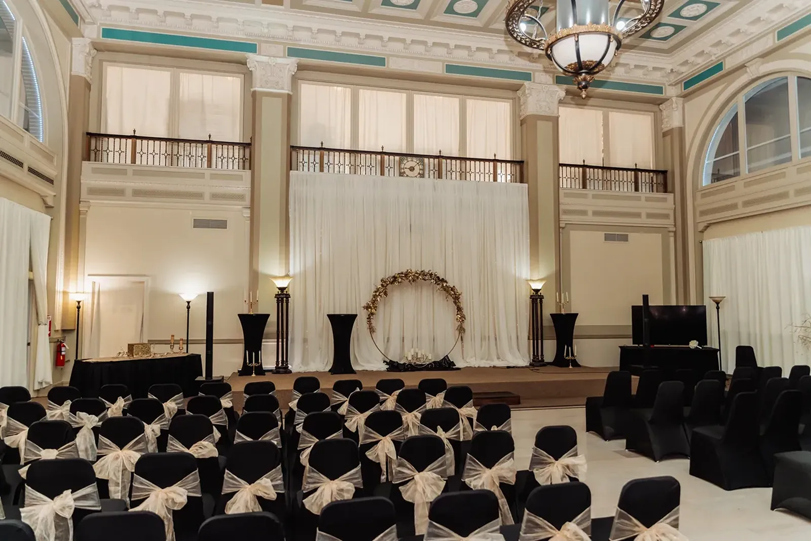 The ballroom and venue 404 with black chairs set up for a ceremony.