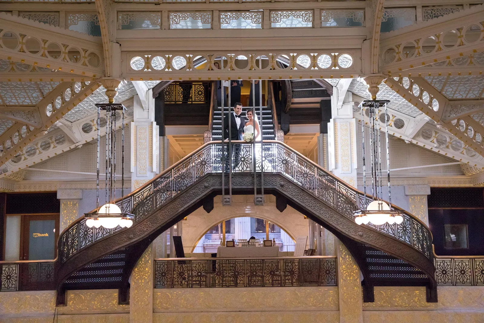 Bride and Groom walk down steps at The Rookery Building a Chicago wedding venue