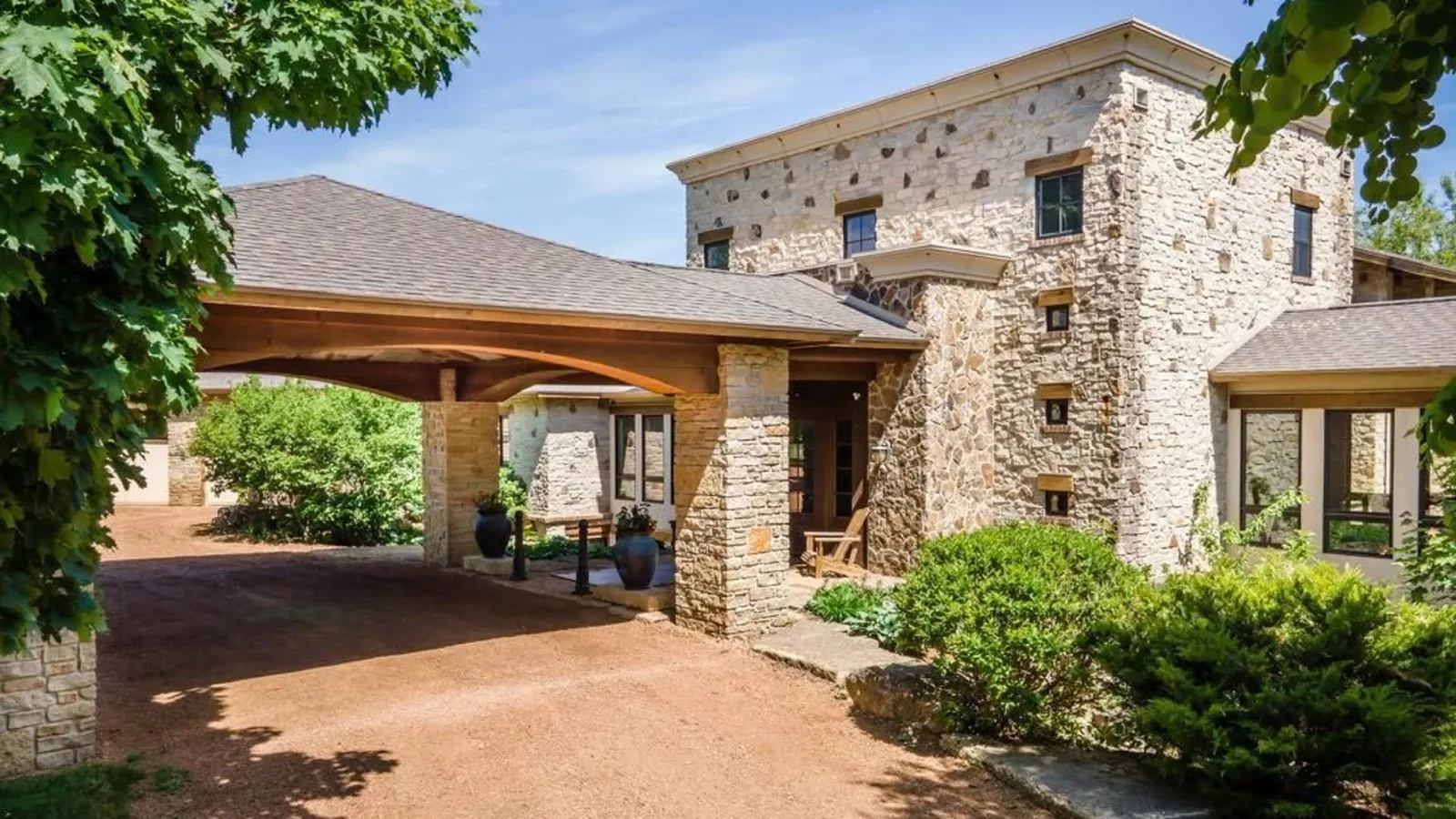 The entryway to Givens Farm LLC with a shaded drive-through space. The house is huge.