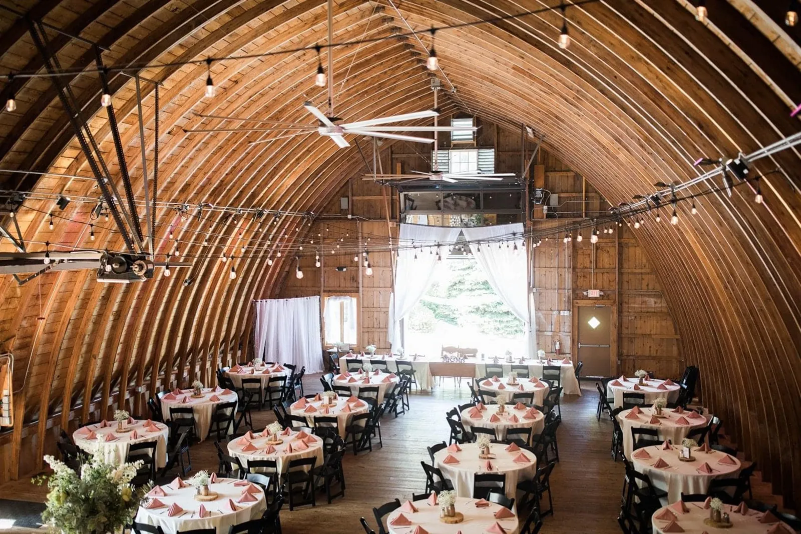 Tables set up for a wedding reception at barn at trinity peak