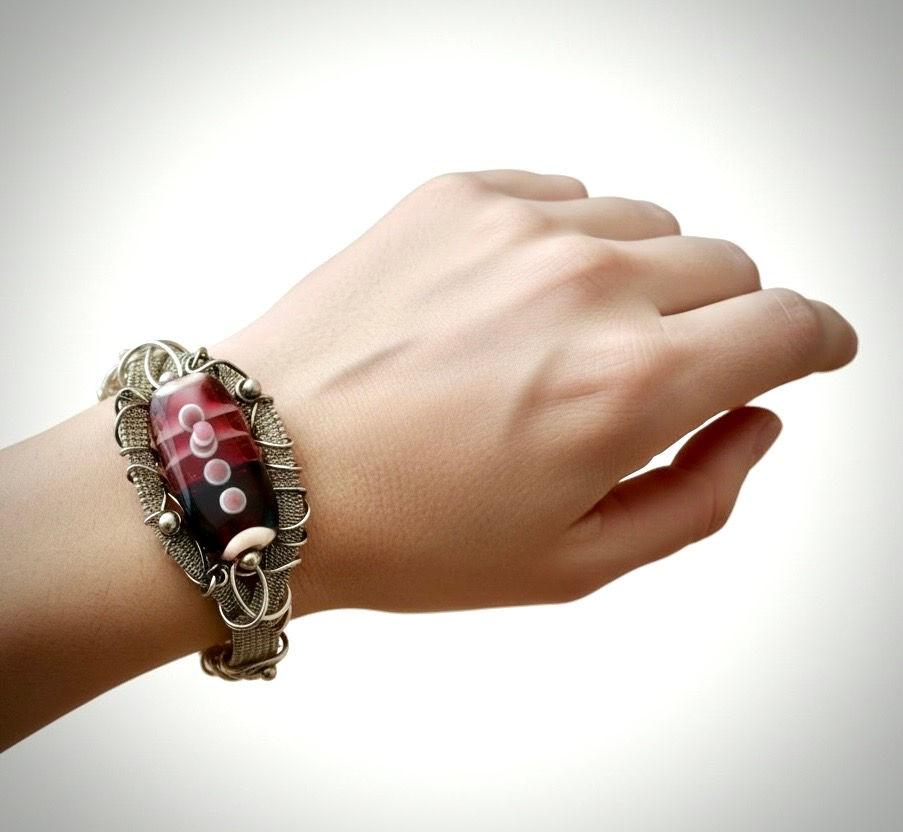 Woven Pink Beauty Bracelet worn on model wrist showing sterling silver wire weaving and pink lampwork bead