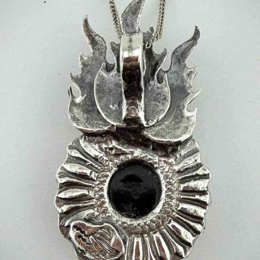Back view of Flaming Set pendant showing fine silver craftsmanship and smooth flame-shaped design