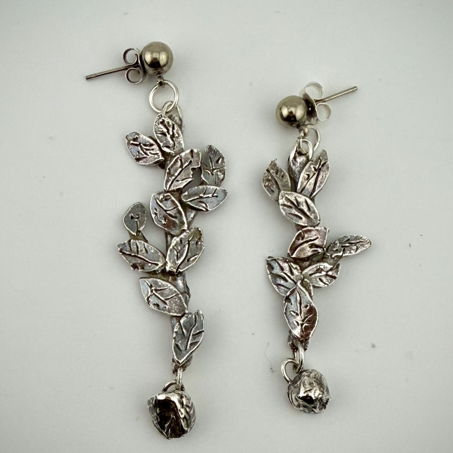 Hungry Giraffe earrings showing matching fine silver leaf and branch design with whimsical botanical theme
